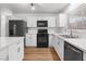 White kitchen with stainless steel appliances and quartz countertops at 4083 Eileen St, Las Vegas, NV 89115