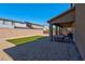 Covered patio, artificial turf, gravel, and seating area at 4128 Fossatello Ave, North Las Vegas, NV 89084