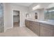 Elegant bathroom with double vanity, granite countertops, and large walk-in closet at 4128 Fossatello Ave, North Las Vegas, NV 89084