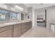 Spacious bathroom with double vanity, granite counters, and a view of the bedroom at 4128 Fossatello Ave, North Las Vegas, NV 89084