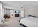 Main bedroom with ensuite bathroom, sliding barn door, and TV at 4128 Fossatello Ave, North Las Vegas, NV 89084