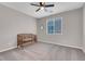 Bright bedroom with carpeted floor, a crib, and a window with blinds at 4128 Fossatello Ave, North Las Vegas, NV 89084