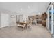 Dining area with table and bench, open to kitchen at 4128 Fossatello Ave, North Las Vegas, NV 89084