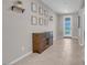 Bright entryway with tile flooring and wood console table at 4128 Fossatello Ave, North Las Vegas, NV 89084