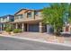 Two-story house with gray siding, stone accents, and a two-car garage at 4128 Fossatello Ave, North Las Vegas, NV 89084