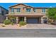 Two-story house with attached garage and landscaping at 4128 Fossatello Ave, North Las Vegas, NV 89084