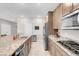 Modern kitchen with stainless steel appliances and granite countertops at 4128 Fossatello Ave, North Las Vegas, NV 89084