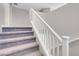 Carpeted staircase with white railing at 4128 Fossatello Ave, North Las Vegas, NV 89084