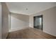 A bright bedroom with wood floors, a neutral color scheme and sliding glass doors at 413 N Lamb Blvd # E, Las Vegas, NV 89110