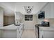 Well-lit kitchen features modern appliances and fixtures with white cabinets and bright countertops at 413 N Lamb Blvd # E, Las Vegas, NV 89110