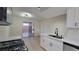 Stylish kitchen featuring white cabinetry, stainless appliances, a sink, and eat-in bar at 413 N Lamb Blvd # E, Las Vegas, NV 89110