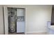 Laundry closet featuring stacked washer and dryer and a water heater at 413 N Lamb Blvd # E, Las Vegas, NV 89110