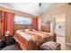 Bedroom with a wooden bed frame and orange bedding at 4314 Flaming Ridge Trl, Las Vegas, NV 89147