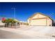 House exterior showcasing a two-car garage and desert landscaping at 4314 Flaming Ridge Trl, Las Vegas, NV 89147