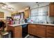 Kitchen with wood cabinets, granite countertops, and stainless steel appliances at 4314 Flaming Ridge Trl, Las Vegas, NV 89147