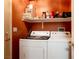 Convenient laundry room with washer, dryer, and shelving at 4314 Flaming Ridge Trl, Las Vegas, NV 89147