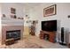 Living area with a fireplace, tv stand, and wood flooring at 4314 Flaming Ridge Trl, Las Vegas, NV 89147