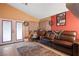 Living room with a brown leather couch and a fireplace at 4314 Flaming Ridge Trl, Las Vegas, NV 89147