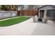 Backyard featuring artificial turf, a fire pit, and ample seating, perfect for outdoor gatherings at 4512 Mark Ave, Las Vegas, NV 89108