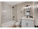 Modern bathroom featuring a tub with marble-style tile surround and a vanity with white cabinets at 4512 Mark Ave, Las Vegas, NV 89108