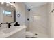 Elegant bathroom with a tiled shower, modern fixtures, and a vanity with quartz countertop at 4512 Mark Ave, Las Vegas, NV 89108