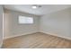 Well-lit bedroom showcasing its hardwood floors, a window that brings in natural light, and ample space at 4512 Mark Ave, Las Vegas, NV 89108