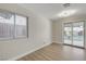 Bright bedroom featuring a large window, new floors, and access to the backyard patio at 4512 Mark Ave, Las Vegas, NV 89108