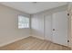 Bedroom featuring wood-look flooring, a window with blinds, and a closet, creating a comfortable and functional space at 4512 Mark Ave, Las Vegas, NV 89108