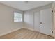 This bedroom has wood-look floors and a bright window at 4512 Mark Ave, Las Vegas, NV 89108