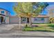 Charming single-story home with a well-manicured front yard, mature shade tree and a two-car garage at 4512 Mark Ave, Las Vegas, NV 89108