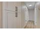 Bright hallway with laminate flooring, modern lighting, and built-in storage cabinets at 4512 Mark Ave, Las Vegas, NV 89108