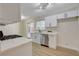 Bright kitchen with stainless steel appliances, white cabinets, and sliding door to backyard at 4512 Mark Ave, Las Vegas, NV 89108