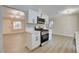 Modern kitchen with white cabinets, quartz countertops, and stainless steel appliances is open to the living area at 4512 Mark Ave, Las Vegas, NV 89108