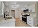 Kitchen with white cabinets, modern appliances, and stylish fixtures, designed for both functionality and aesthetic appeal at 4512 Mark Ave, Las Vegas, NV 89108