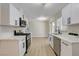 Bright kitchen with stainless steel appliances, white cabinets, and ample counter space, ideal for culinary enthusiasts at 4512 Mark Ave, Las Vegas, NV 89108