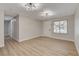 Cozy living room with laminate floors, a large window, and modern ceiling lights at 4512 Mark Ave, Las Vegas, NV 89108