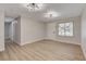 Inviting living room with new floors, white walls, and a window overlooking the front yard at 4512 Mark Ave, Las Vegas, NV 89108