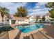 Sparkling community pool with a patio, lounge chairs, and a fenced area at 4869 S Torrey Pines Dr # 101, Las Vegas, NV 89103