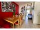 Charming dining area features red accent wall and seating for four at 5266 Lisagayle Ct # 124, Las Vegas, NV 89103