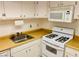 Efficient kitchen with white appliances, ample counter space, and storage at 5266 Lisagayle Ct # 124, Las Vegas, NV 89103