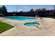 Community pool area with a hot tub, lounge chairs, and well-maintained deck at 5266 Lisagayle Ct # 124, Las Vegas, NV 89103