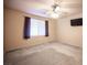 Bedroom with a ceiling fan, TV, and window with blinds and curtains at 536 Roberta Alecia Ave, North Las Vegas, NV 89031