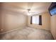 Bedroom with a ceiling fan, TV, and window with blinds and curtains at 536 Roberta Alecia Ave, North Las Vegas, NV 89031