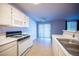 Well-lit kitchen features white appliances and convenient dining area access at 536 Roberta Alecia Ave, North Las Vegas, NV 89031