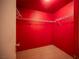 This walk-in closet features a red paint scheme, wire shelving and ceramic tile flooring at 536 Roberta Alecia Ave, North Las Vegas, NV 89031