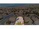 This is a nice home aerial of desert landscape with solar panels and surrounding houses at 5468 Carrara Pointe St, Pahrump, NV 89061