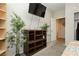 Bedroom featuring shelving, indoor plants, and mounted flat screen television at 5468 Carrara Pointe St, Pahrump, NV 89061