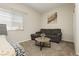 Cozy bedroom featuring neutral tones, carpet flooring, and a comfortable sofa with a round table at 5468 Carrara Pointe St, Pahrump, NV 89061