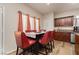 Cozy dining area features seating for six with updated, dark wood cabinets and stainless steel appliances at 5468 Carrara Pointe St, Pahrump, NV 89061