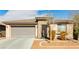 Inviting single-story home with desert landscaping, complemented by stone accents and a two-car garage at 5468 Carrara Pointe St, Pahrump, NV 89061